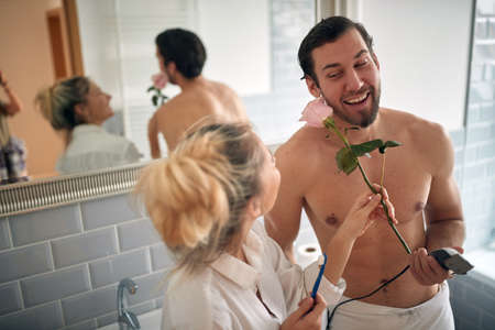 Endearing couple brushing teeth together in the morningの写真素材