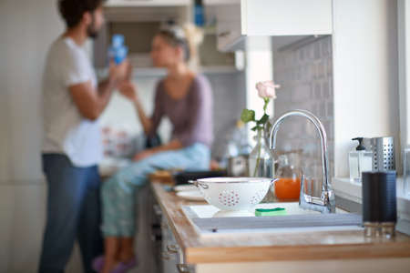 A young couple in love in a relaxed atmosphere at the kitchen. Cooking, home, kitchen, relationship
