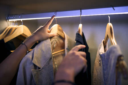 A business woman at hotel room who choosing clothes for work. Business, hotel, peopleの写真素材