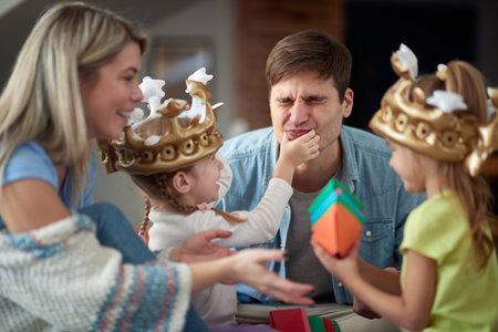 Young family having fun while playing in a cheerful atmosphere at home. Family, playing, home, togethernessの写真素材