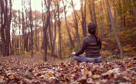 connect with mothernature and breathing fresh air, woman meditating in forest. Busting energy.の写真素材