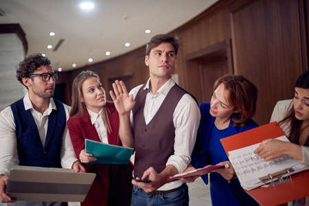 A team carefully listening to their manager in a working atmosphere of the briefing at the hotel...