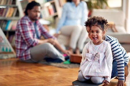 Kids enjoying the playtime with their parents in a cheerful atmosphere at home. Family, together, love, playtimeの写真素材