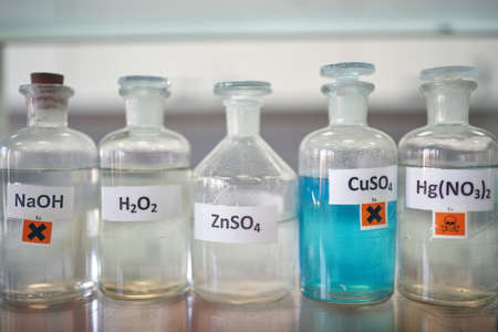 Dangerous chemicals on the shelf in a sterile environment of the laboratory. Chemistry, lab,...