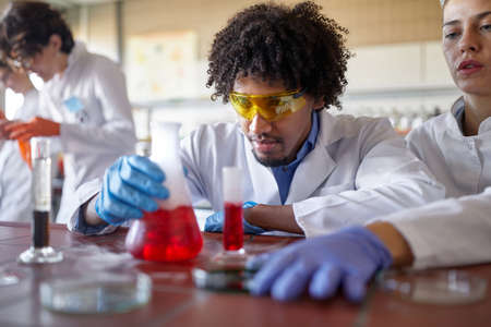 Medical students conducting chemical experiment in the labの写真素材