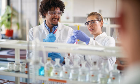 Two young medical students conducting chemical experiment in the lab