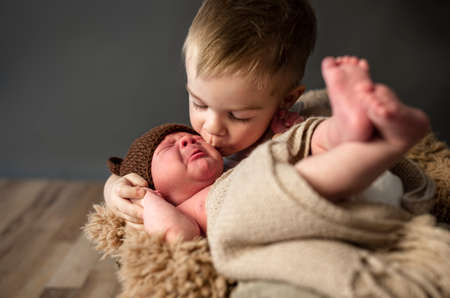 Little boy kissing his little crying brother, and comforted himの写真素材