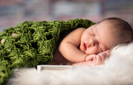 Newborn baby sleeping on a white fluffy blanket, sweet dreamの写真素材