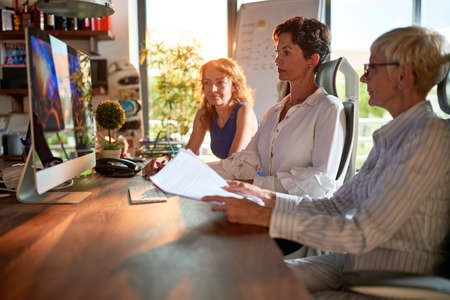 Group of female colleagues working together in the officeの写真素材