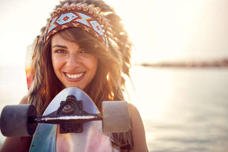 Close-up of a young beautiful girl with a war bonnet on her headの写真素材