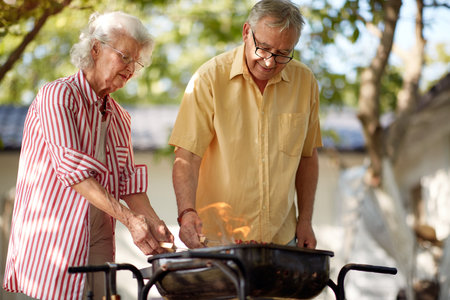 elderly caucasian couple making barbequeの写真素材