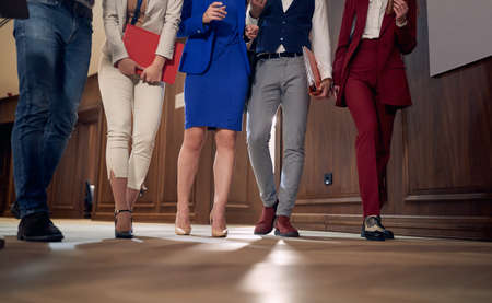 cropped image of businesspeople walking through hallwayの写真素材