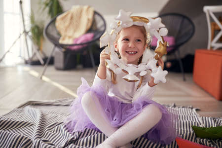 A little girl playing on the floor in a relaxed atmosphere at home. Play, childhood, home