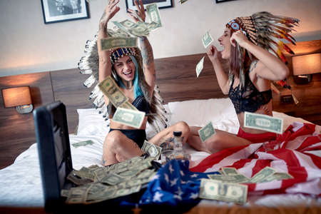 Two hot girls having fun together in bedの写真素材