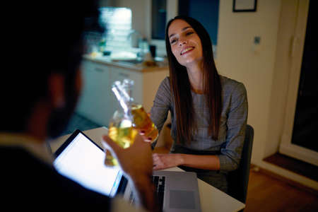 colleagues after a hard day work, having a toast on valentine evening, glad, satisfied and flirting.