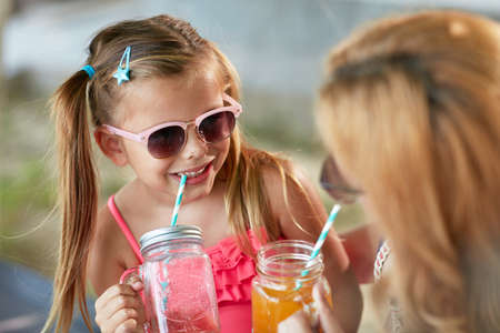 adorable  little caucasian girl having fun with her mom