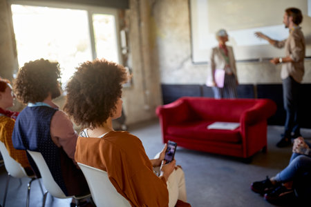 Group of young creative people is following a lecture in a relaxed atmosphere in the officeの写真素材