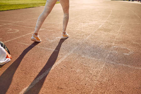 Female jogger working out alone outside on the running trackの写真素材