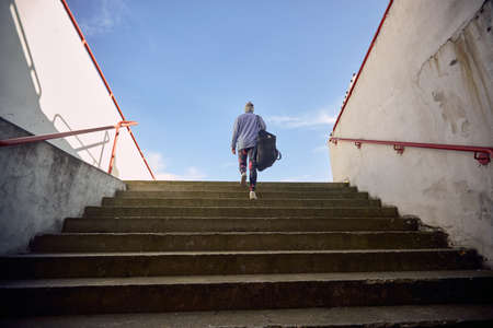 Fit woman jogging alone outside on the stairsの写真素材
