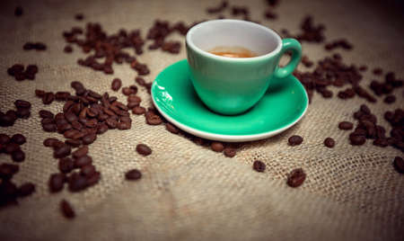Fresh coffee beans and hot espresso cup.mug of delicious fresh coffeeの写真素材