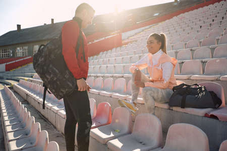 Sporty couple chatting together outside after trainingの写真素材