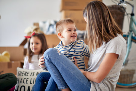 Happy caucasian family with two children moving in new placeの写真素材