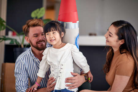 Carefree multi ethnic family moving in together into new home; New beginning conceptの写真素材