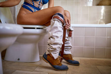 Young woman having constipation problems on the toiletの写真素材