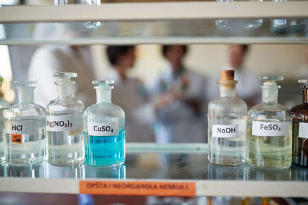 Bottles with different chemicals on the shelf in a sterile laboratory environment. Science, chemistry, lab, peopleの写真素材