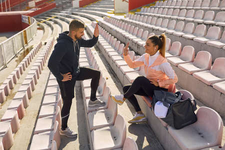 Sporty friends hanging out casually together after trainingの写真素材