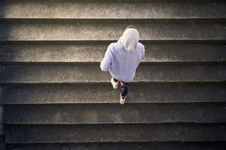 A shot of a young girl from above jogging on stairs on a beautiful day at the stadium. Sport, athletics, athletesの写真素材