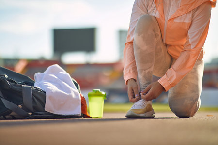 A young woman in an athletic training preparation on a beautiful day at the stadium. Sport, athletics, athletesの写真素材