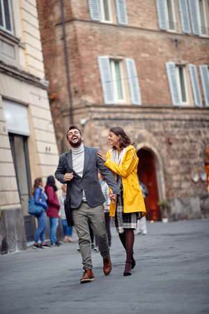 Happy couple enjoying the walk in the city togetherの写真素材