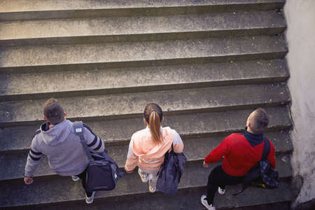 A group of young people is arriving at the stadium to have a training on a beautiful day. Sport, athletics, athletesの写真素材