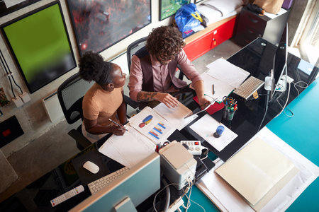 Young motivated colleagues doing reports togetherin the officeの写真素材