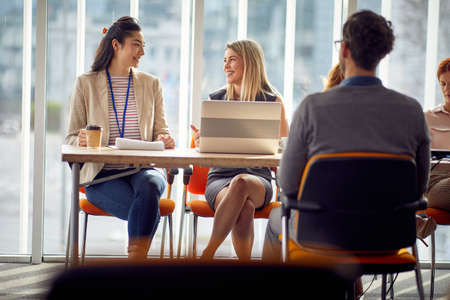 Young female commission enjoying an interview with job applicant in a relaxed atmosphere. Business,...