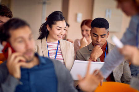 A group of young business people is enjoying a business lecture in a relaxed atmosphere in the conference room. Business, people, meeting, companyの写真素材