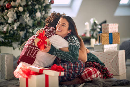 Embracing smiling girl and man for Christmas.の写真素材
