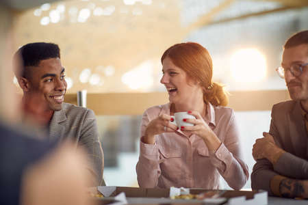 Happy business people talking and laughing together