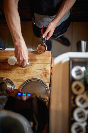 A bird-eye view on barman's hands working behind the bar in a working atmosphere. Coffee, beverage, barの写真素材