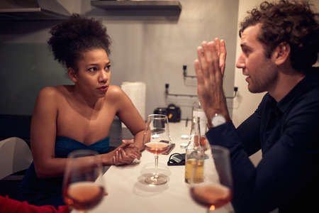 man and woman talking and drinking at home  together