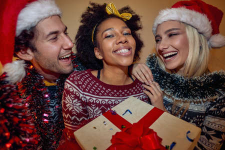 Multiethnic group of happy friends celebrating the New Year together indoorsの写真素材