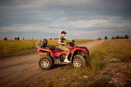 Young girl  driving off-road and enjoying on extreme ridingの写真素材