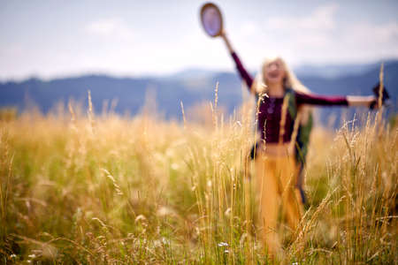 Blurred shot of a young hiker woman enjoying nature with open arms. Carefree, sunny, freedom, happy. Sport, freedom, holiday concept.の写真素材