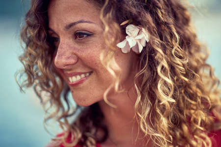 beautiful smiling girl with a flower in her hairの写真素材