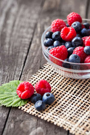 bowl with red raspberry, black blueberry, freshly picked berries concept