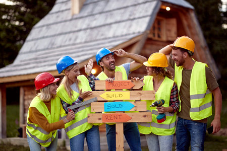 Young construction workers team working on a mountain cottage project together