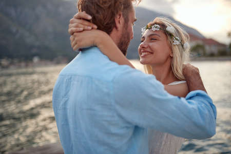 Bride and groom on honeymoon in embrace. Happy bride looking at husband. Wedding, honeymoon, love...