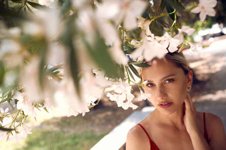 Dreaming beautiful woman in blooming flower