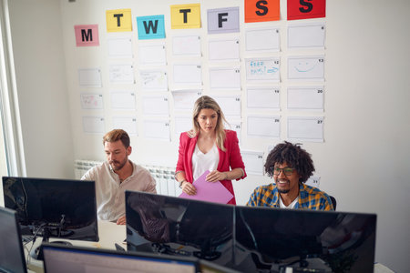 Group of young colleagues working together in the office